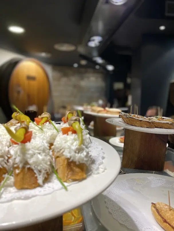 A variety of pinchos presented on the counter in a restaurant
