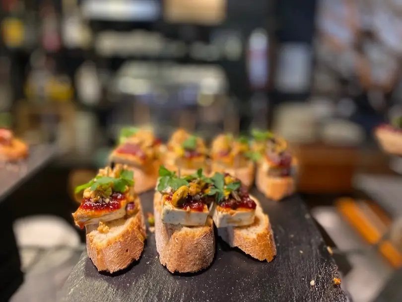 Spanish snacks called pinchos with a cheese and jam topping