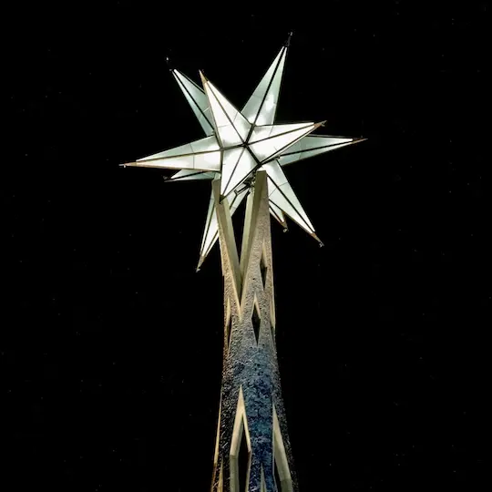A massive illuminated sculpture in shape of a star is crowning the top of the Mary Tower of Sagrada Familia in Barcelona.