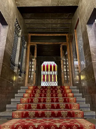 The central staircase of Gaudí's Palau Guëll features a rich stained-glass window showing the Catalan flag.