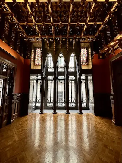A room in Gaudí's Palau Guëll that is richly ornated with an exclusive coffered ceiling.