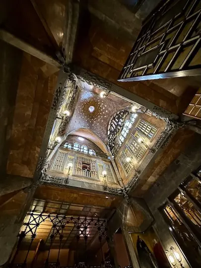 View up in the central hall of Gaudí's Palau Guëll towards the dome that crowns the building.